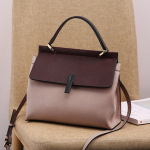 genuine leather shoulder tote bag on a chair.