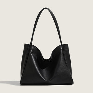 Black leather handbag on a light gray background
