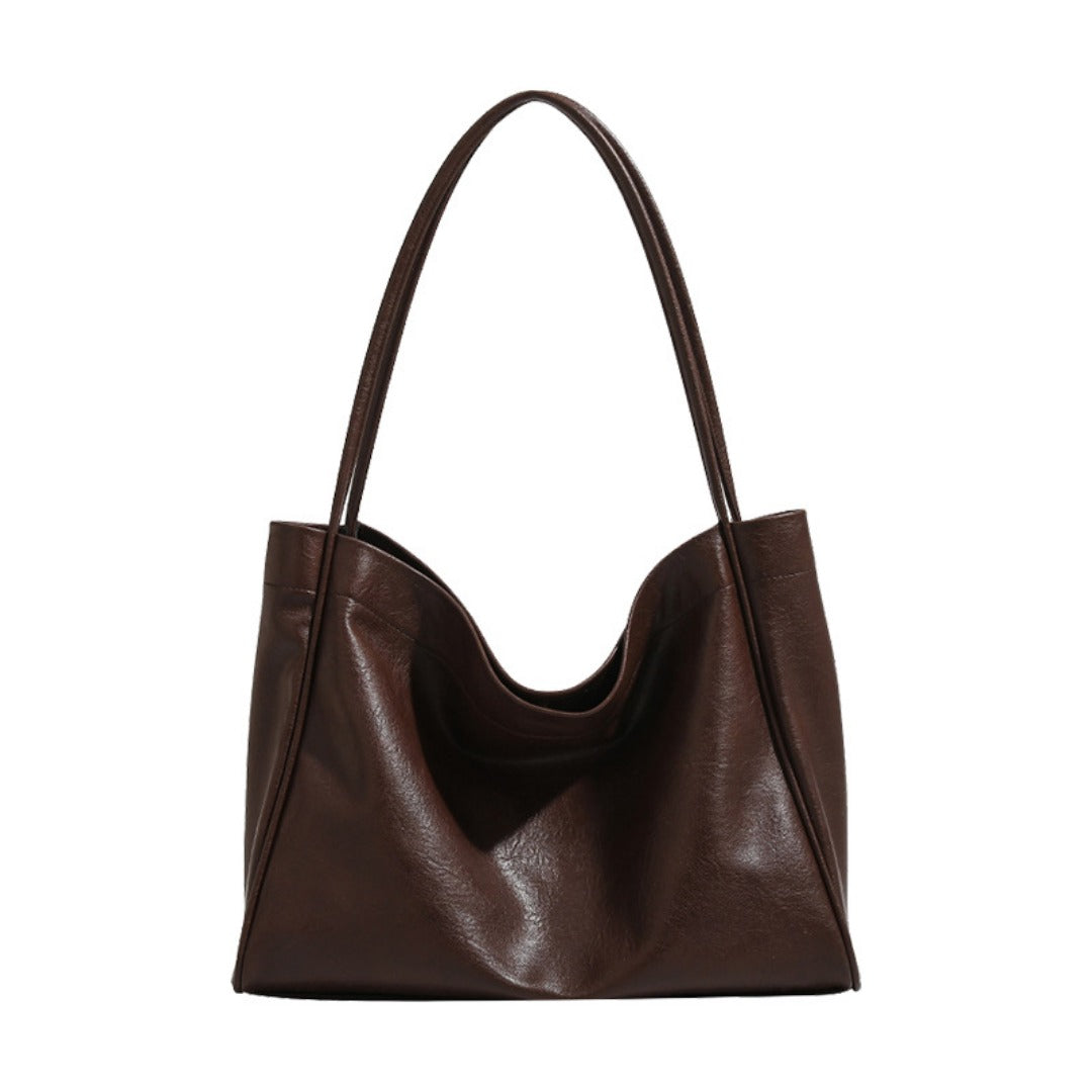 Brown leather handbag on a white background
