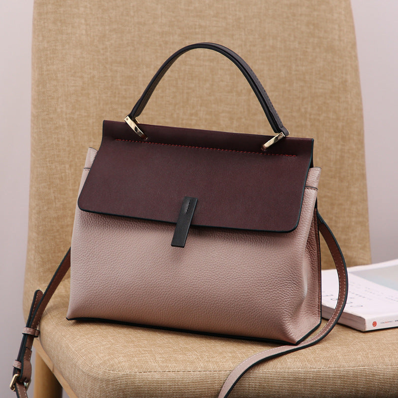 genuine leather shoulder tote bag on a chair.