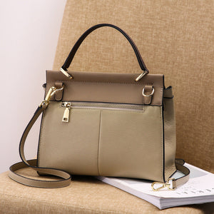 Beige genuine leather shoulder tote bag on a beige surface.