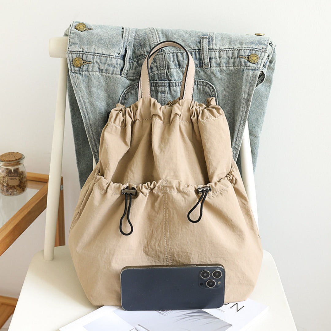 Lightweight drawstring bucket backpack in beige with top handles
