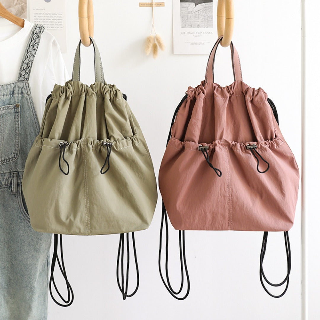 Casual bucket backpack shown in multiple everyday colors