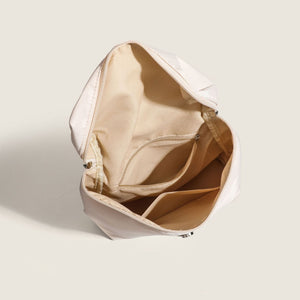 Beige backpack with open front pocket on a light gray background