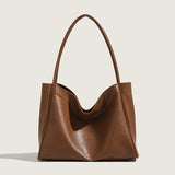 Brown leather handbag on a light beige background