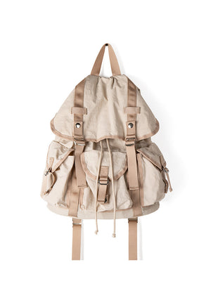 Beige backpack with brown straps on a white background