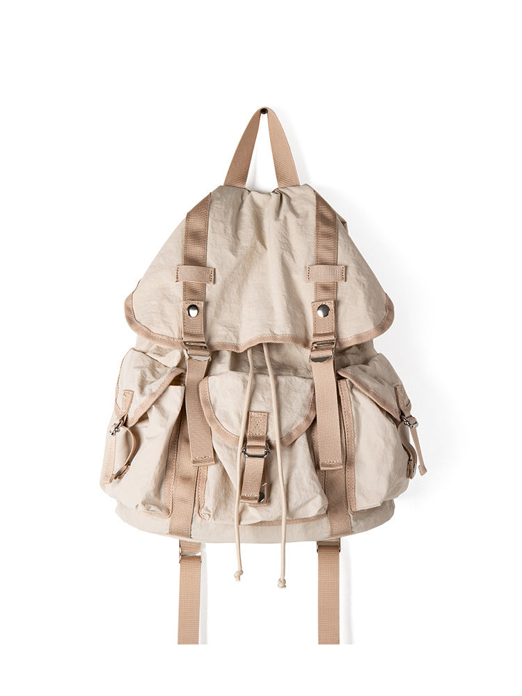 Beige backpack with brown straps on a white background