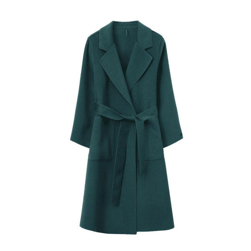Green women's loose fit mid-length coat with a belt on a white background