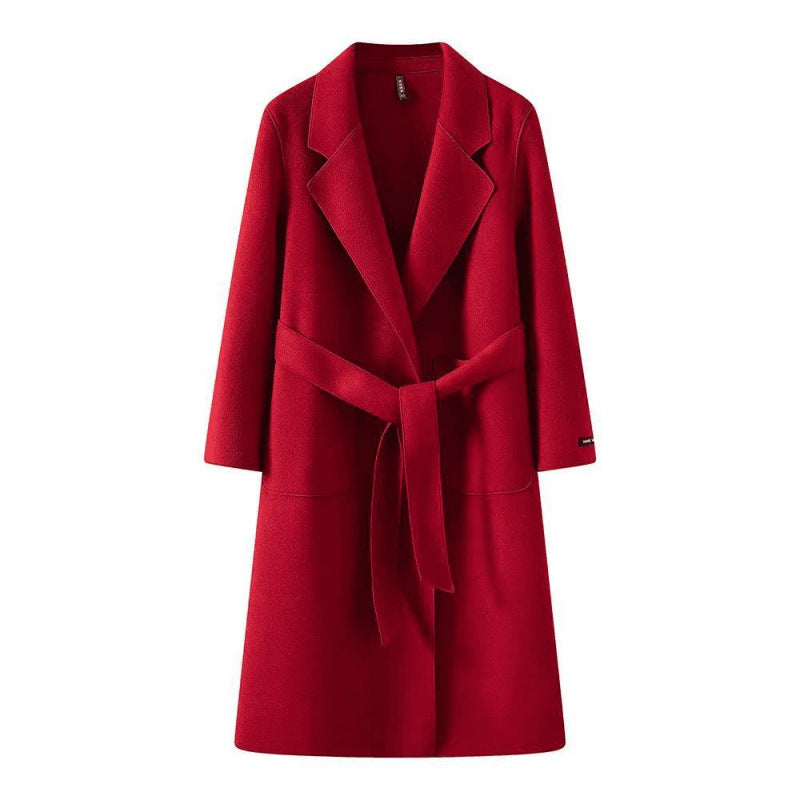 Red women's loose fit mid-length coat with a belt on a white background