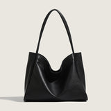 Black leather handbag on a light gray background