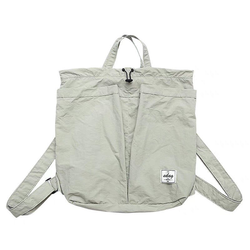 Light gray backpack with a visible brand label on a white background