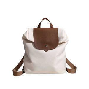nylon commuter backpack with brown leather flap and straps on a white background
