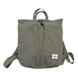 Green backpack with a visible brand logo on a white background