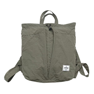 Green backpack with a visible brand logo on a white background