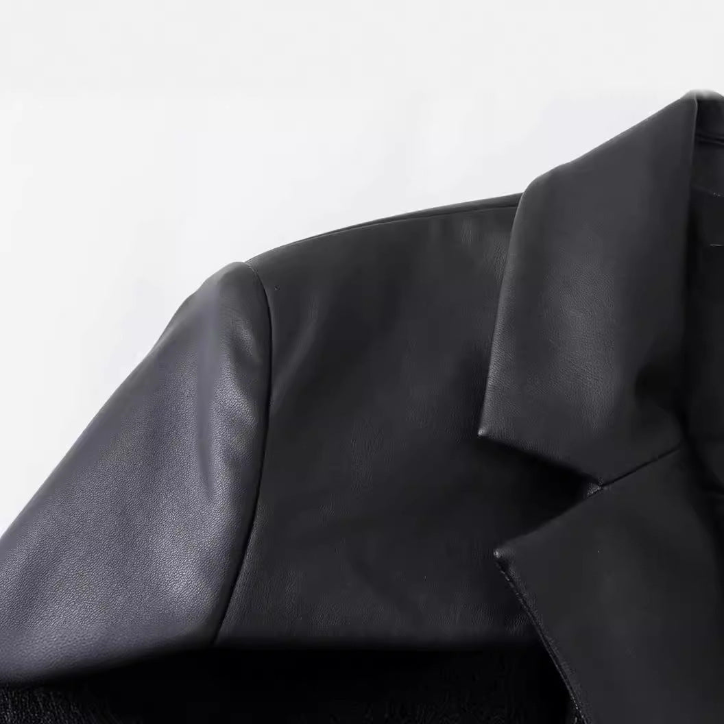 Close-up of a black leather jacket on a white background