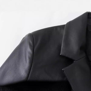Close-up of a black leather jacket on a white background