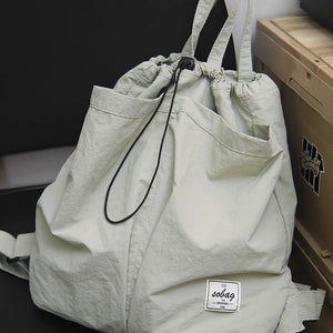 large capacity nylon backpack purse with a visible brand label on a dark background