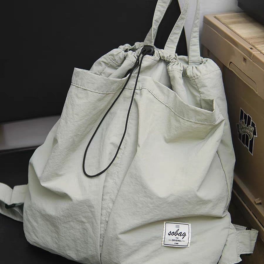 large capacity nylon backpack purse with a visible brand label on a dark background