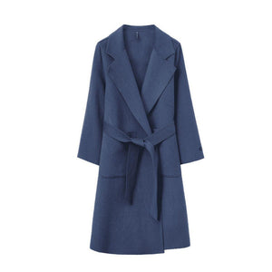 Blue coat with a belt on a white background