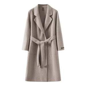 women's loose fit mid-length coat with a belt on a white background
