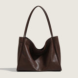 Brown leather handbag on a light beige background