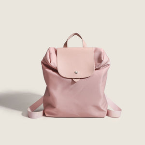 Pink backpack on a light beige background